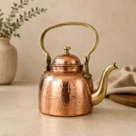 Handmade hammered copper tea kettle with brass handle and spout