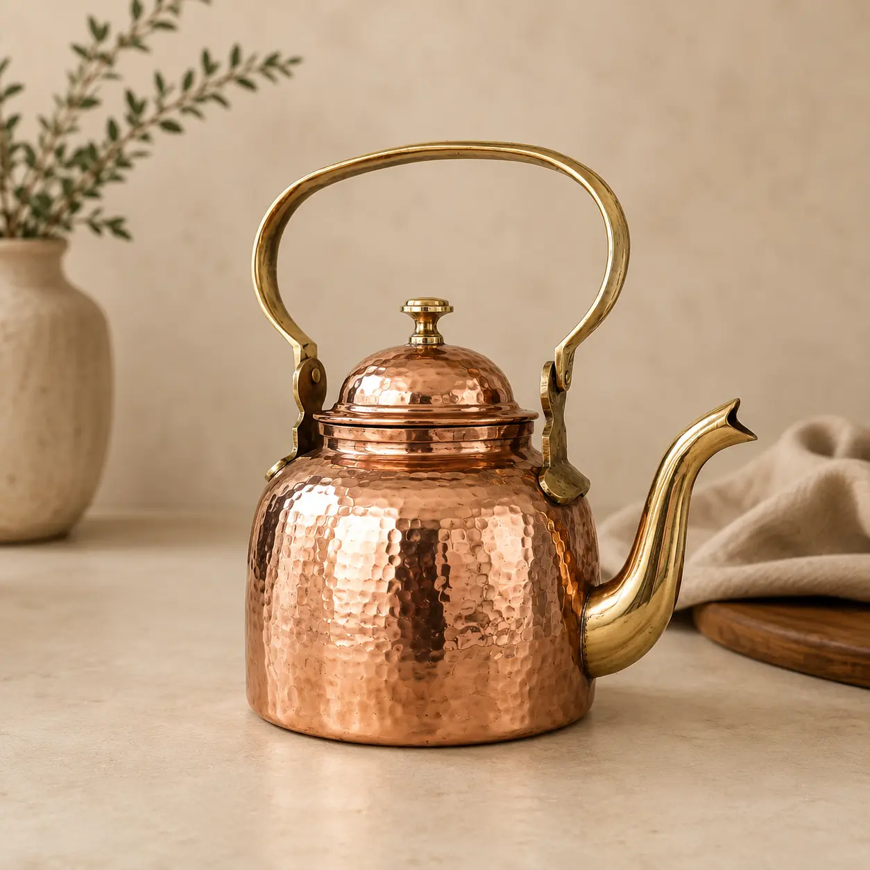 Handmade hammered copper tea kettle with brass handle and spout