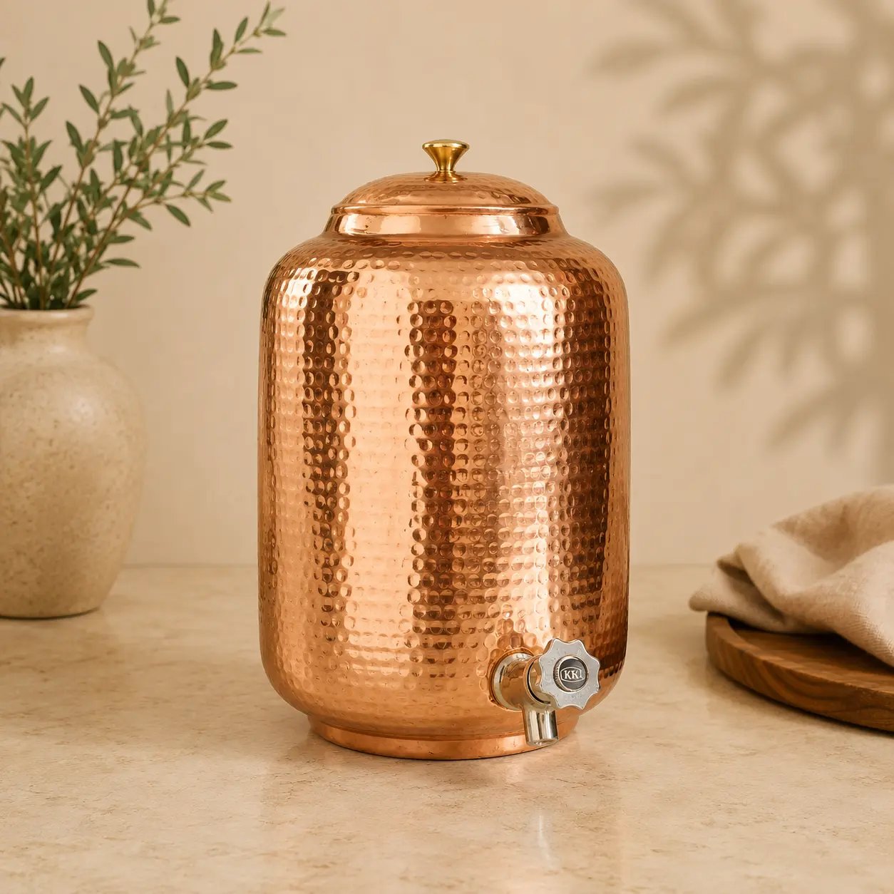 Handmade copper water dispenser with brass spigot, lid, and hand hammered finish